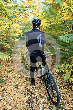 Man riding a bike in forest with helmet