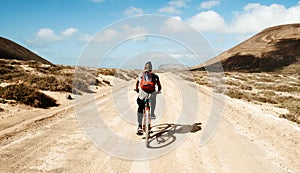 Man riding a bike in La Graciosa, Canary Islands, Spain