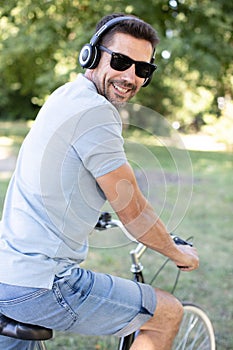 man riding black and white bicycle