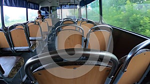 Man riding bus. Woman sitting on seat and riding inside empty old authentic bus