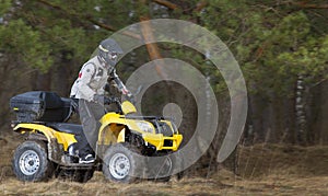 Man riding dirty 4x4 ATV quad bike