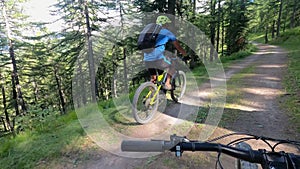Man is riding electric mountain bike on forest path Slowmotion video