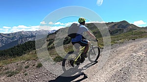 Man is riding electric mountain bike on top of mountain Slowmotion video