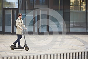 Man Riding Electric Scooter in City