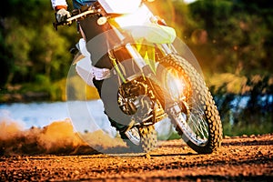 Man riding enduro motorcycle on dirt field