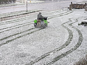 Man Riding a Fertilizer Spreader In Snow