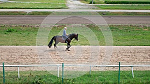 Man riding a horse gallop gracefully on a race track