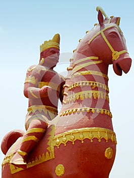 Man riding a horse terracotta statuette against blue sky in public park