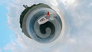 A man is riding an inflatable boat in a 360-degree panorama