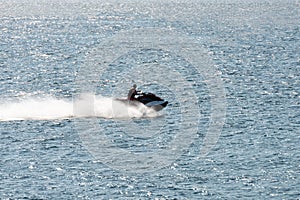 Man riding a jet ski shooting in backlit