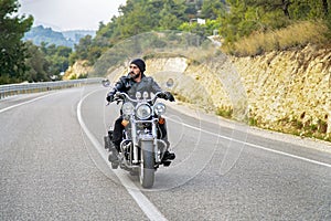 Man riding motorcycle on an empty country road.