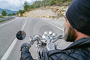 Man riding motorcycle on an empty country road.
