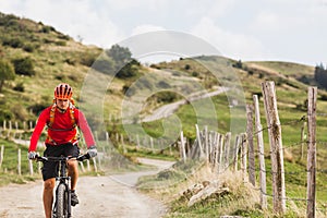 Man riding mountain bike on country road