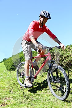 Man riding mountain bike on a hot summer day