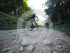 Man Riding Mountain Bike On Rocks Trail.