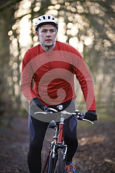 Man Riding Mountain Bike Through Woodlands photo
