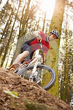 Man Riding Mountain Bike Through Woods