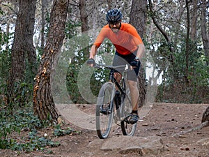 Man riding mtb mountain bike through forest. Mountain bike trail, extreme sport activities