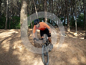 Man riding mtb mountain bike through forest. Mountain bike trail, extreme sport activities