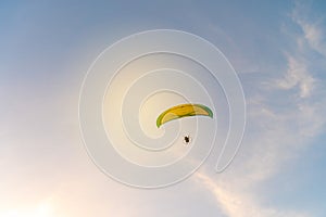 Man is riding para motor in beautiful sunset.