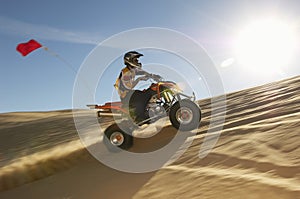 Man Riding Quad Bike In Desert