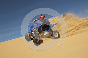 Man Riding Quad Bike In Desert