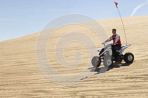 Man Riding Quad Bike In Desert