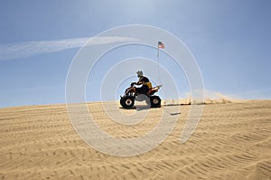 Man Riding Quad Bike In Desert