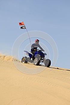 Man Riding Quad Bike In Desert