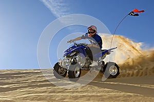 Man Riding Quad Bike In Desert