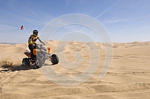 Man Riding Quad Bike In Desert