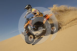 Man Riding Quad Bike In Desert photo