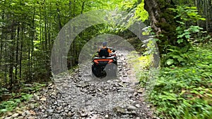 Man riding on quad bike in mountain. Tourist on quad bike on beautiful nature background. People, leisure and vacation