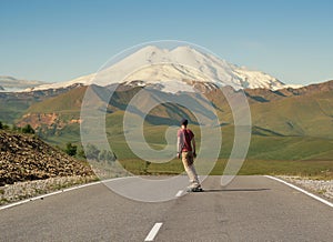 Man Riding on skateboard on Road to Elbrus
