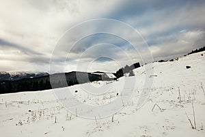 A man riding a snowboard down a snow covered slope