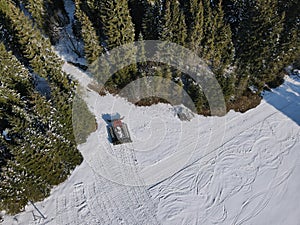 A man riding a snowboard down a snow covered slope