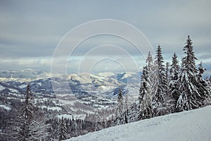 A man riding a snowboard down a snow covered slope