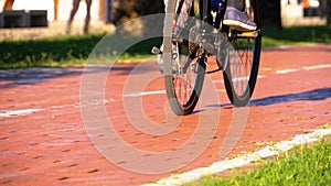 Man Riding an Three-wheeled Electric Scooter on Bike Path in the Park. Slow Motion