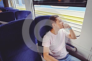 Man is riding a train, traveling by rail