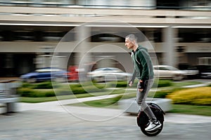 Man riding unicycle on street