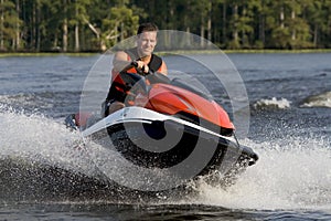 Man riding wave runner in river