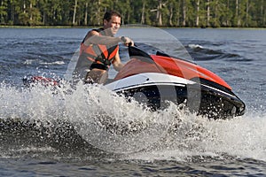 Man riding wave runner in river