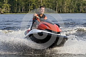 Man riding wave runner in river