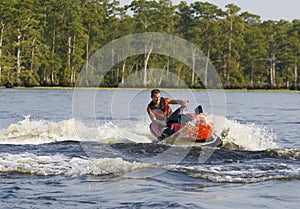 Man riding wave runner in river