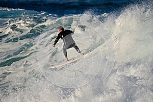 A man riding a wave on a surfboard in the ocean