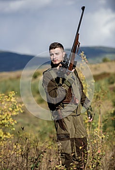 Man with rifle hunting equipment nature background. What you should have while hunting nature environment. Recharge