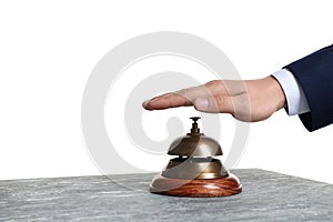 Man ringing hotel service bell at stone table