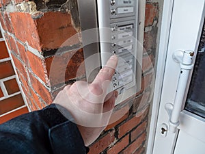 Man rings the doorbell symbolic