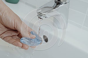 rinses his occlusal splint in his bathroom sink photo