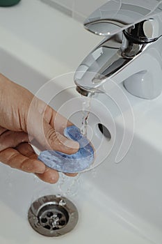 man rinsing his occlusal splint photo